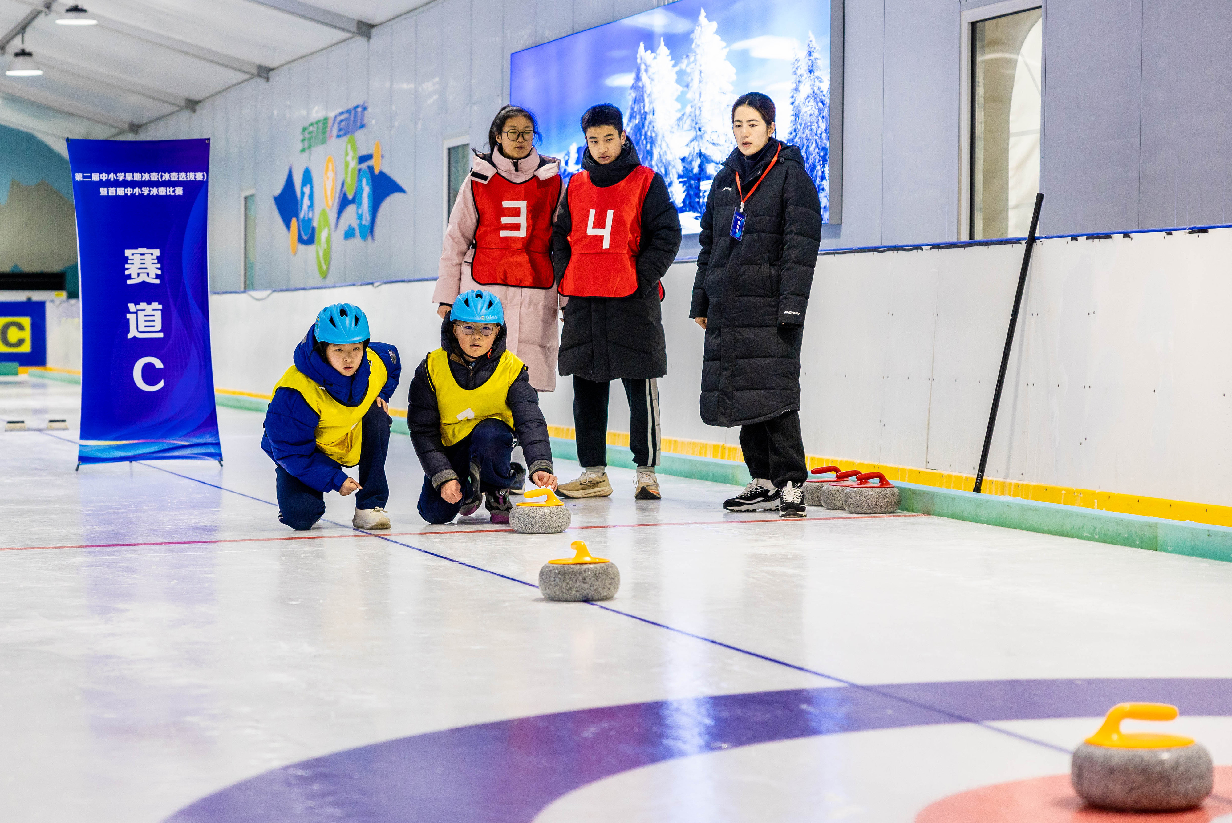 2023年12月10日,參賽選手在呼和浩特首屆中小學冰壺比賽中投擲冰壺。
